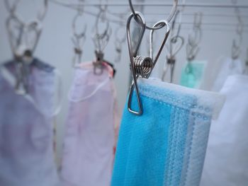Close-up of blue hanging on metal for sale