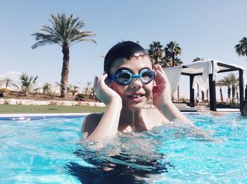 Portrait of happy boy swimming in pool