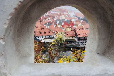 Buildings seen through window of ancient fortress
