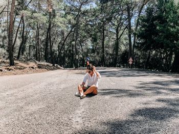 Young couple sitting on road