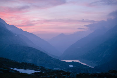 Scenic view of snowcapped mountains against sky during sunset