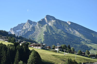 Scenic view of mountains against clear blue sky