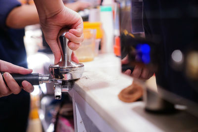 Close-up of man preparing coffee