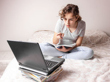 Young woman using laptop at home