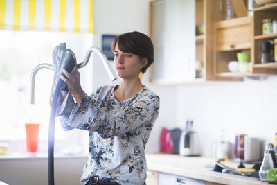 Upcycling young woman in a kitchen