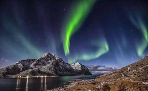 Scenic view of snowcapped mountains against sky at night