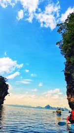 People enjoying in sea against sky