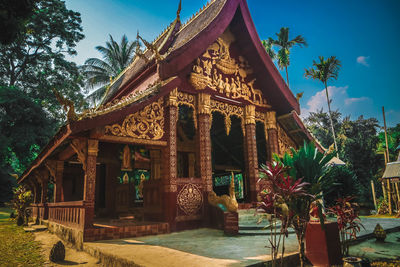 Temple by building against sky