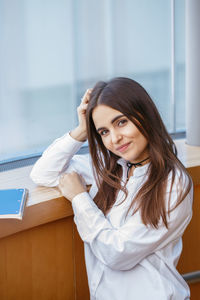 Portrait of smiling young woman with long hair