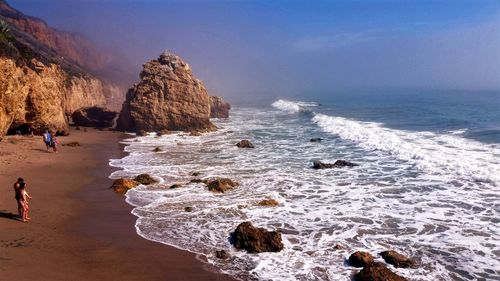 Scenic view of sea against blue sky on sunny day