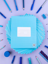 High angle view of school supplies on white background