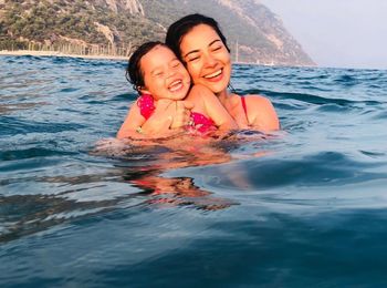 Portrait of smiling woman with sea in background