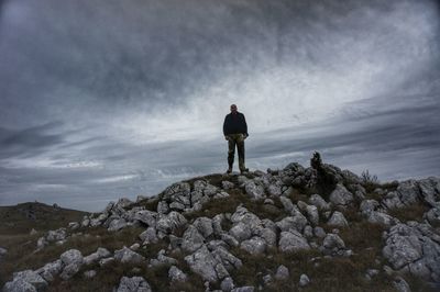 Rear view of man standing on rock