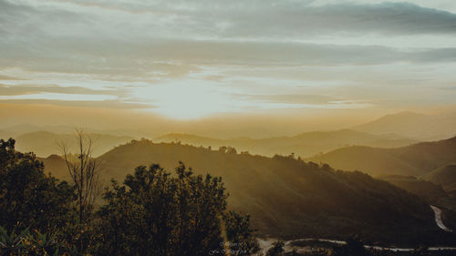 Scenic view of silhouette mountains against sky at sunset