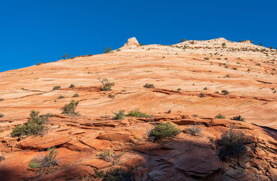 Zion national park low angle landscape of almost barren striped stone hillside at checkerboard mesa