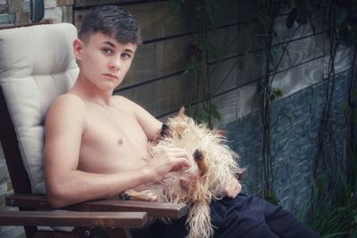 Portrait of shirtless boy sitting at home