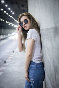 Young woman wearing sunglasses standing outdoors