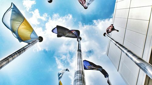 Low angle view of people against blue sky