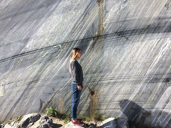 Young woman standing on railing