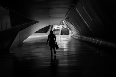 Rear view of silhouette person walking in subway