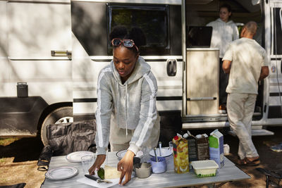 Woman setting camping table