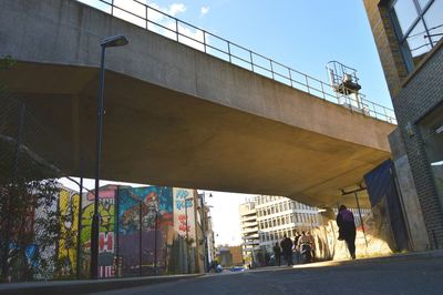 People walking on bridge in city