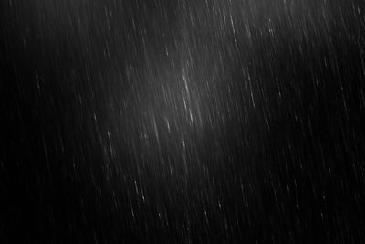 Full frame shot of raindrops on black background