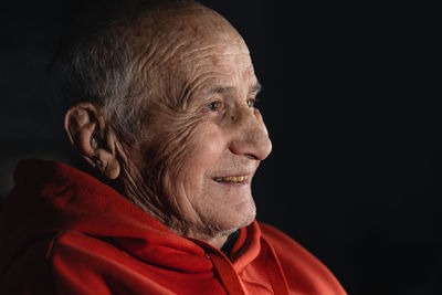 Close-up of man against black background