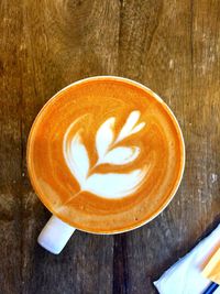 Directly above shot of coffee cup on wooden table