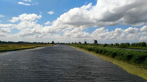 Road by river against sky