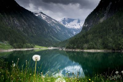 Scenic view of lake and mountains against sky