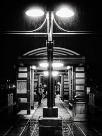 Illuminated lamp post at night