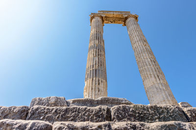 Low angle view of old ruin against clear blue sky