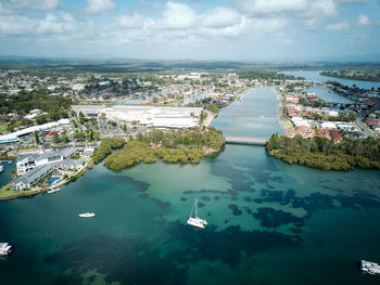 High angle view of buildings by sea against sky