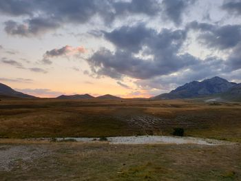 Scenic view of field against sky during sunset