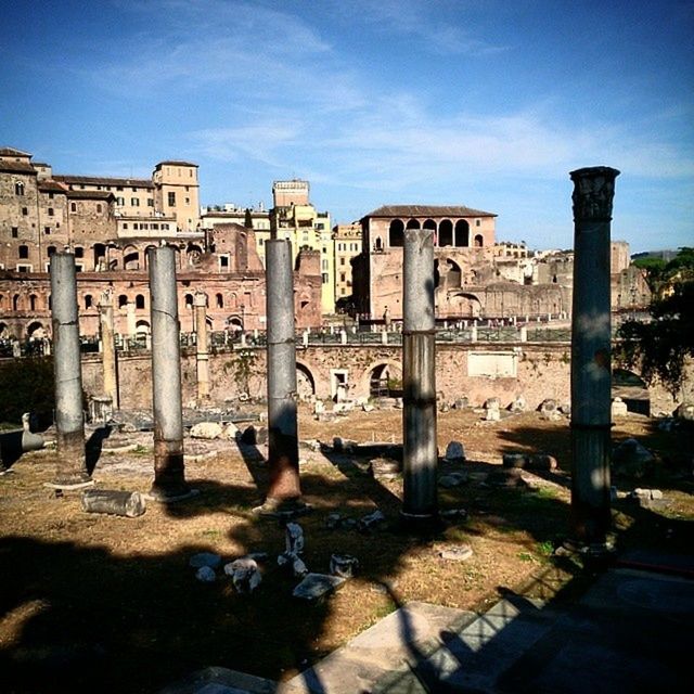 architecture, built structure, building exterior, animal themes, water, sky, men, one animal, sunlight, city, person, lifestyles, day, outdoors, shadow, incidental people, blue, architectural column, travel destinations