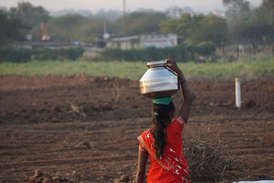 Rear view of person working on field