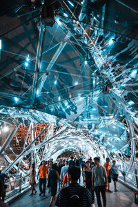 Rear view of people watching illuminated ceiling