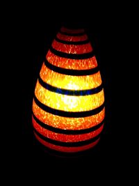 Close-up of lamp over black background