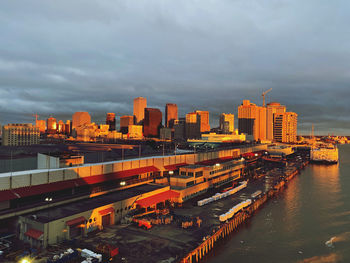 High angle view of river by buildings in city against sky