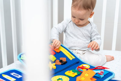 Portrait of boy playing with toy blocks at home