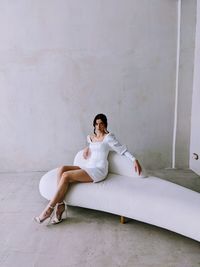 Young woman sitting on floor