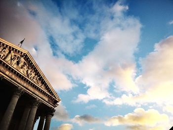 Low angle view of building against cloudy sky