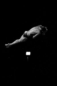 High angle view of shirtless man against black background