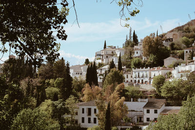 Buildings in town against sky