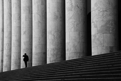 Rear view of man and woman walking on staircase
