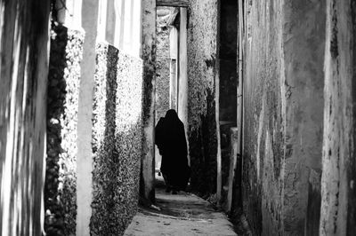 Woman walking at alley