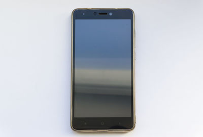 Close-up of smart phone over white background