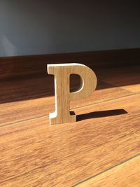 Close-up of text on wooden table