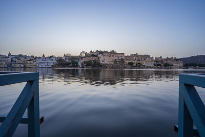 Reflection of buildings in city at waterfront